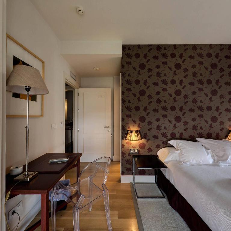 Postel nebo postele na pokoji v ubytování Hotel Palacio Muñatones