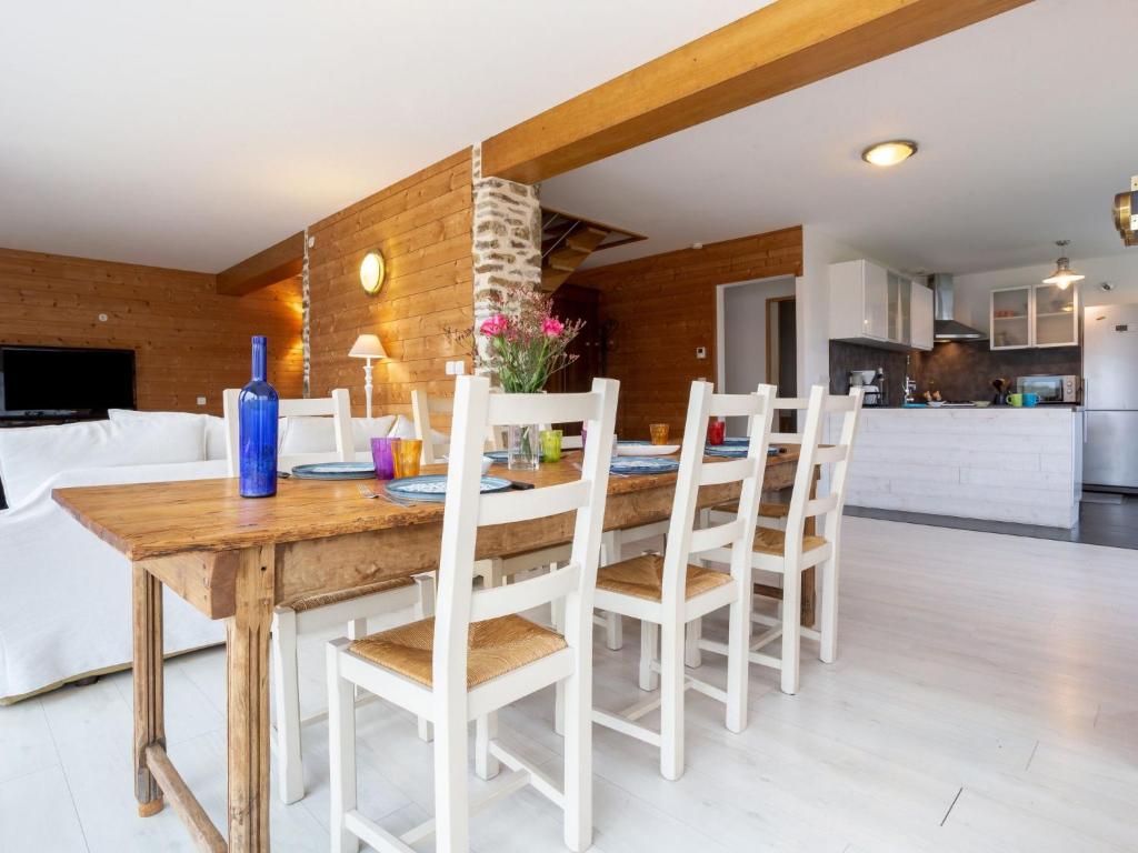 a kitchen and dining room with a wooden table and chairs at Holiday Home La Plage by Interhome in Denneville