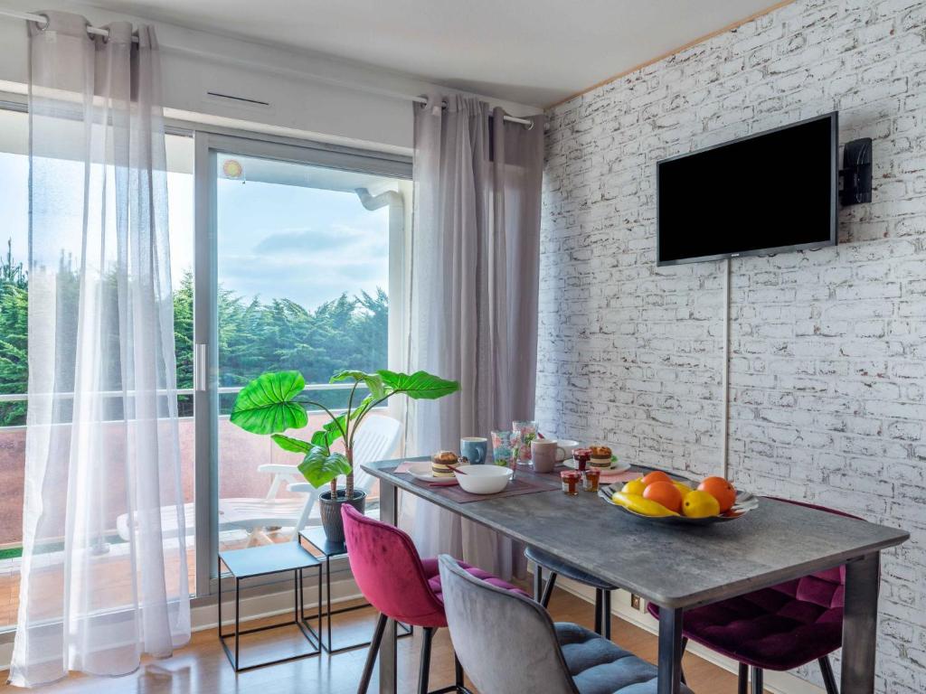 a dining room with a table and a large window at Studio Adal d'Arvor by Interhome in Quiberon