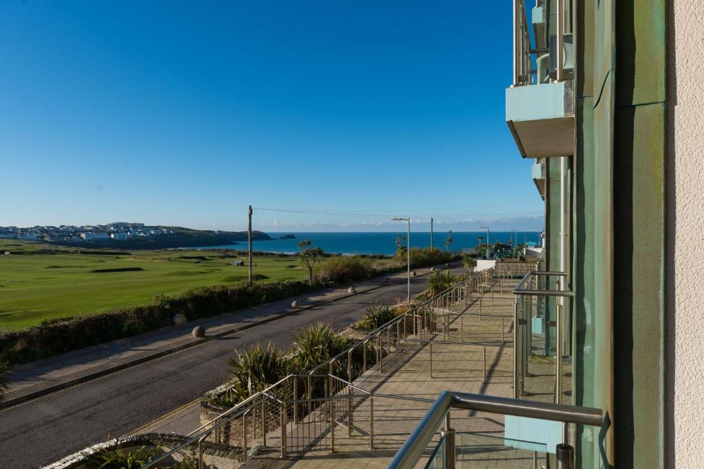 a balcony with a view of the ocean from a building at 22 Zinc in Newquay