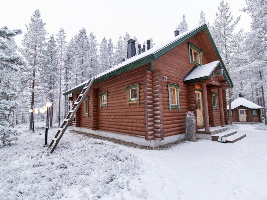 a log cabin in the woods in the snow at Holiday Home Petsankolo by Interhome in Pyhätunturi