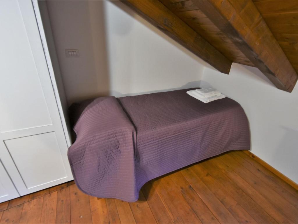 A bed or beds in a room at Studio Albergo Diffuso - Cjasa de Pagnocca by Interhome