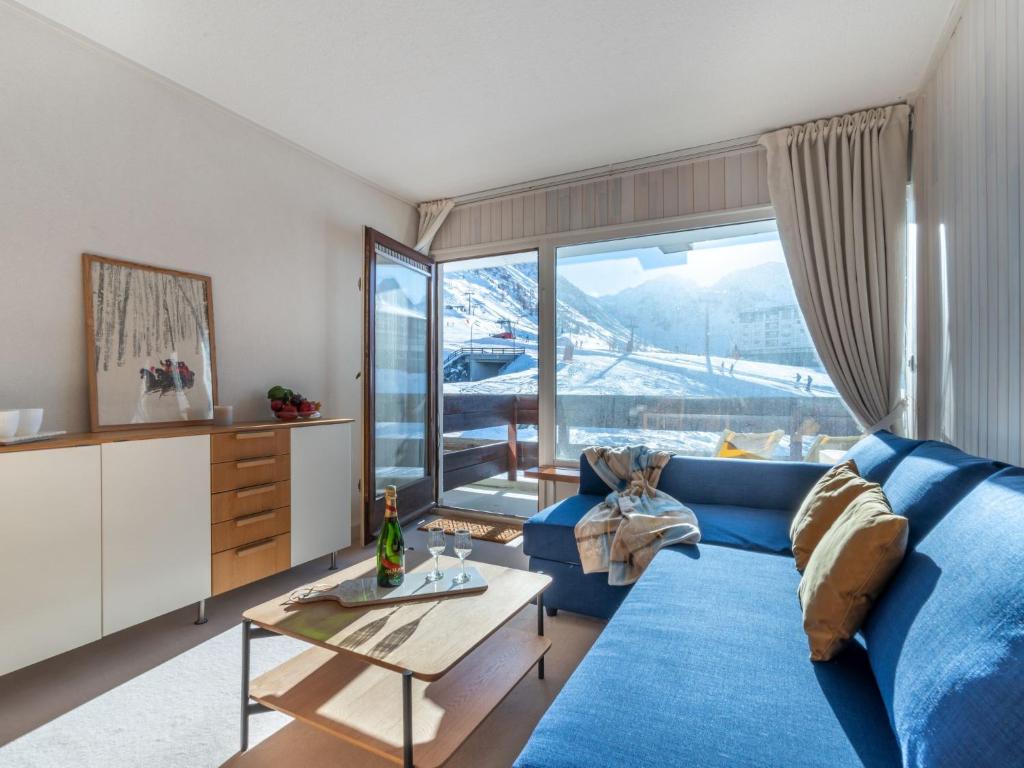 a living room with a blue couch and a table at Studio Les Pistes - Lavachet-4 by Interhome in Tignes