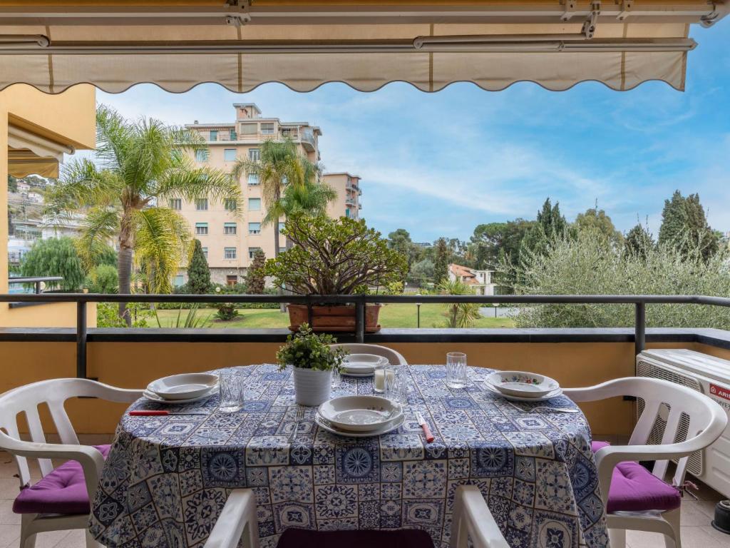 a table on a balcony with a view of a building at Apartment Acqua marina by Interhome in Sanremo