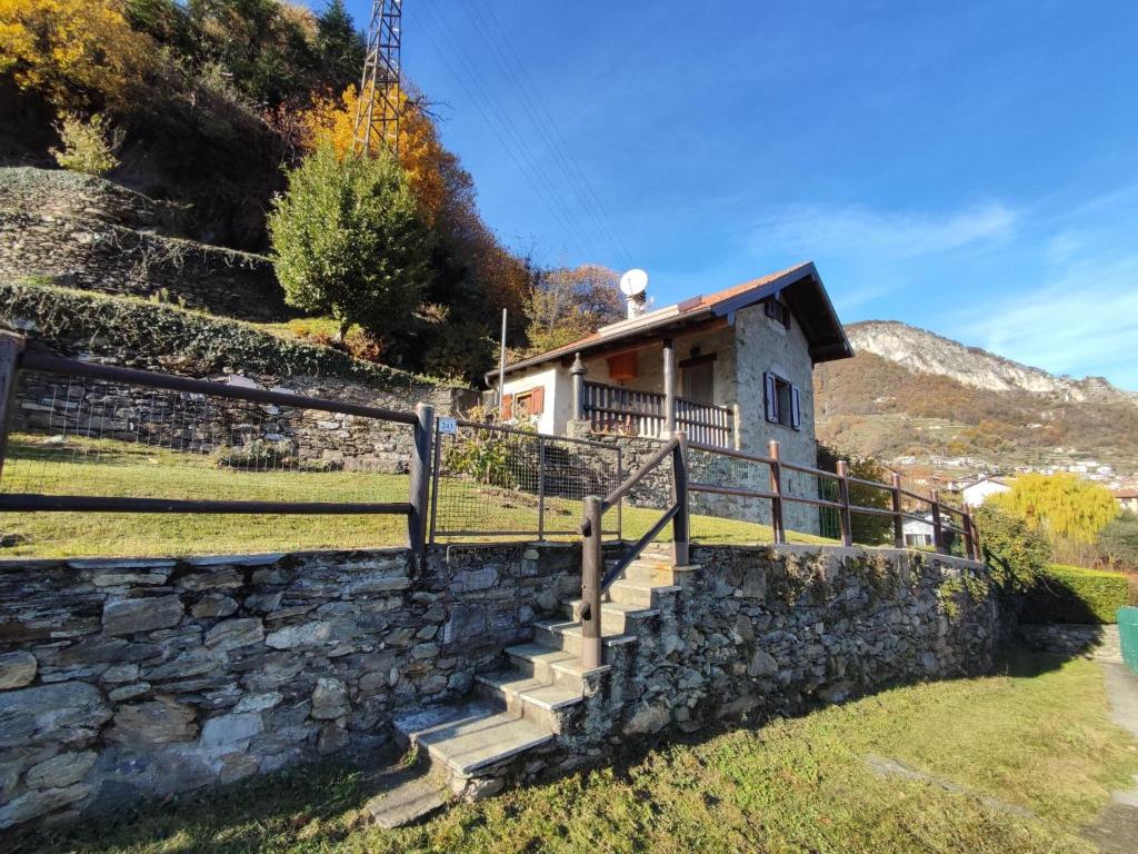 a house on a hill with a stone wall at Holiday Home Il Crotto by Interhome in Pianello Del Lario