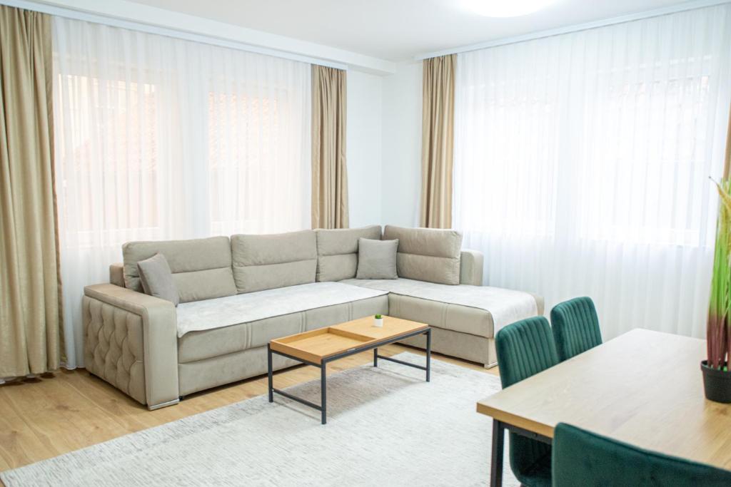 a living room with a couch and a table at CENTRAL Aparments in Novi Pazar