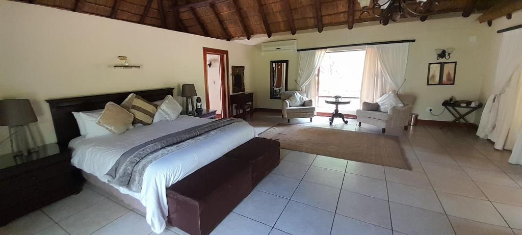 a bedroom with a large bed in a room at PHAKELA PRIVATE LODGE in Thabazimbi