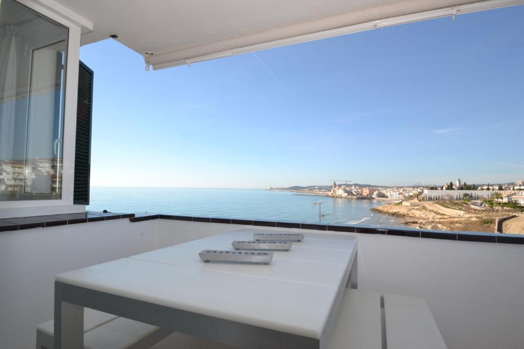 a white balcony with a view of the ocean at Viva Sitges - Sitges View in Sitges