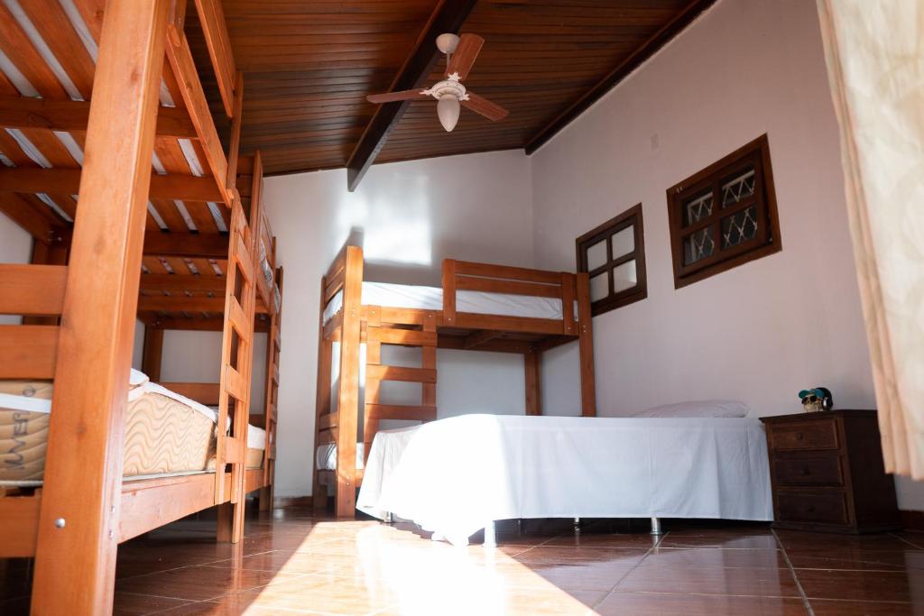 a bedroom with two bunk beds and a ceiling at Woods Hostel in Belo Horizonte