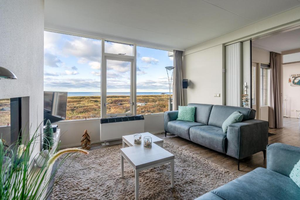 a living room with a couch and a table at Appartementencomplex Juliana 114 in De Koog