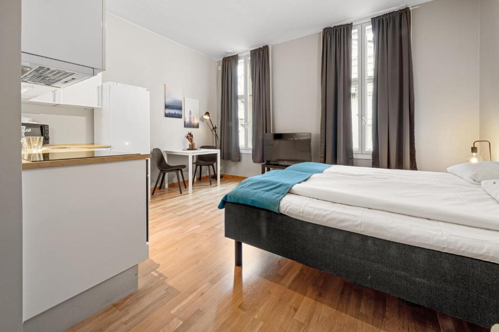 a hotel room with a bed and a kitchen at Forenom Serviced Apartments Oslo Nobel in Oslo