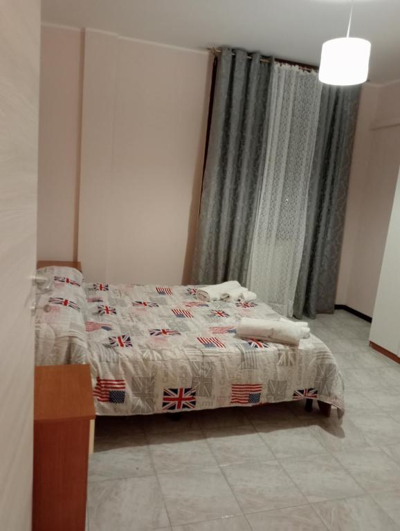 a bedroom with a bed with a blanket on it at Marino in Sassuolo