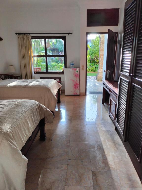 Postel nebo postele na pokoji v ubytování Grand Kumala Hotel - Hotel Kumala Legian Kuta Bali