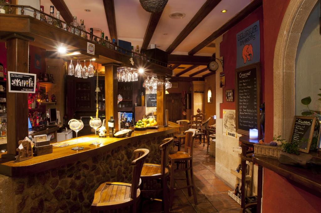 a bar in a restaurant with chairs and tables at Hotel Triskel in Jávea