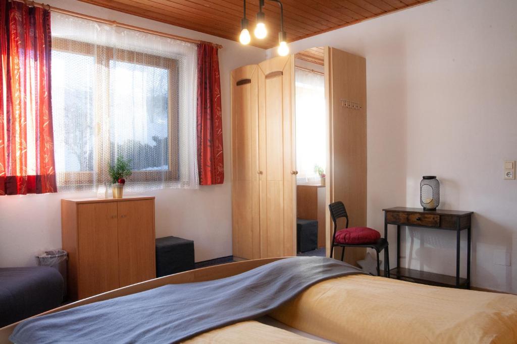 a bedroom with a bed and a window at Appartement Heidi by Schladmingurlaub in Ramsau am Dachstein