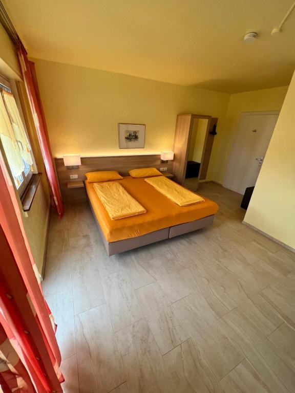 a large bedroom with two beds in it at Hotel-Heilsberg in Gottmadingen