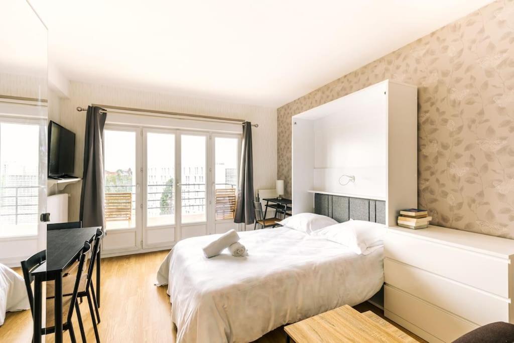 1 dormitorio con cama grande y ventana grande en Marvellous Studio Paris 14 en Gentilly