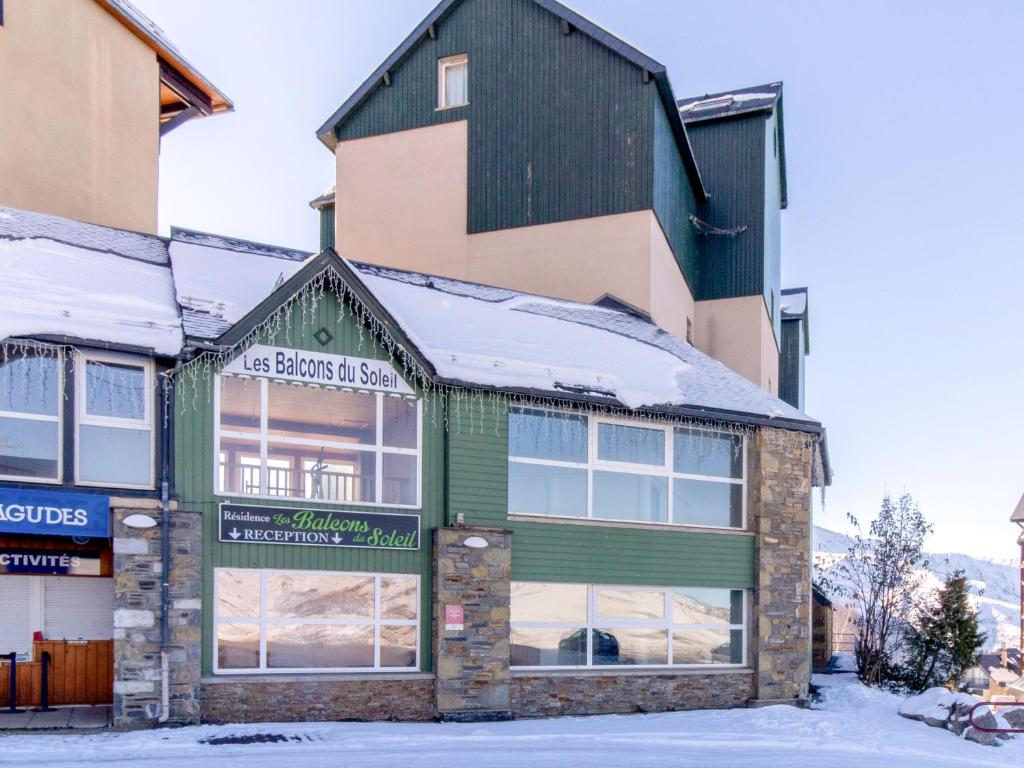 a building with snow on the roof at Vacancéole - Les Balcons du Soleil in Germ