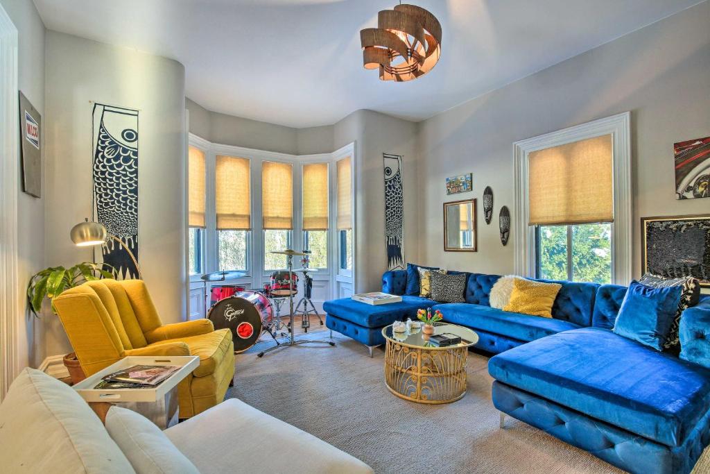 a living room with blue couches and yellow chairs at Pet-Friendly Millerton Home, Walk to Downtown in Millerton