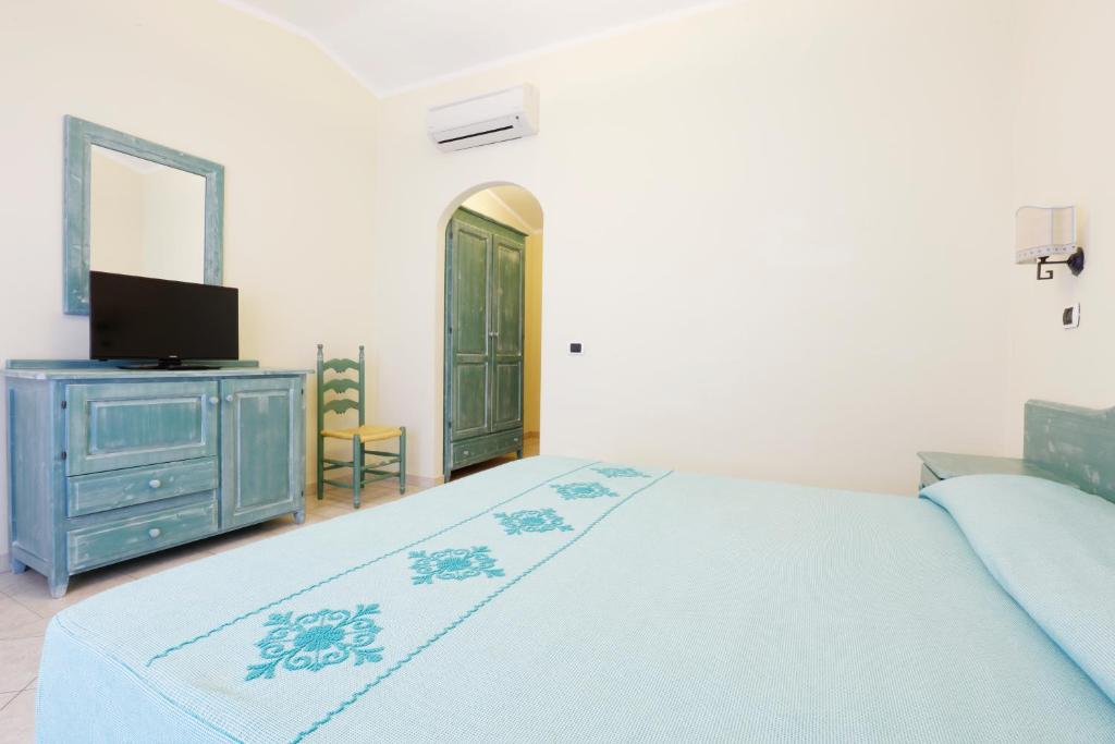 Postel nebo postele na pokoji v ubytování Hotel Baia Aranzos