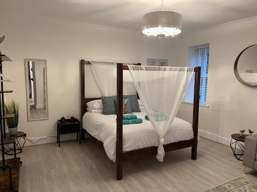 a bedroom with a bed with a canopy at Large Three bed Two bathroom flat in Central Torquay in Torquay
