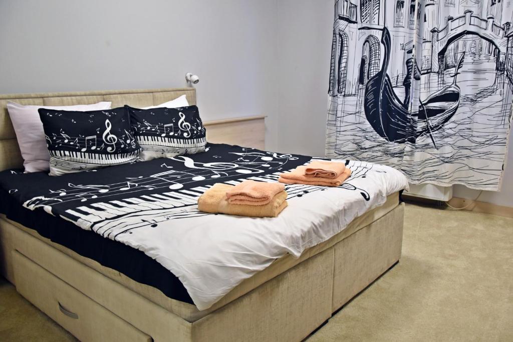 a bedroom with a bed with towels on it at City SMART in Niš