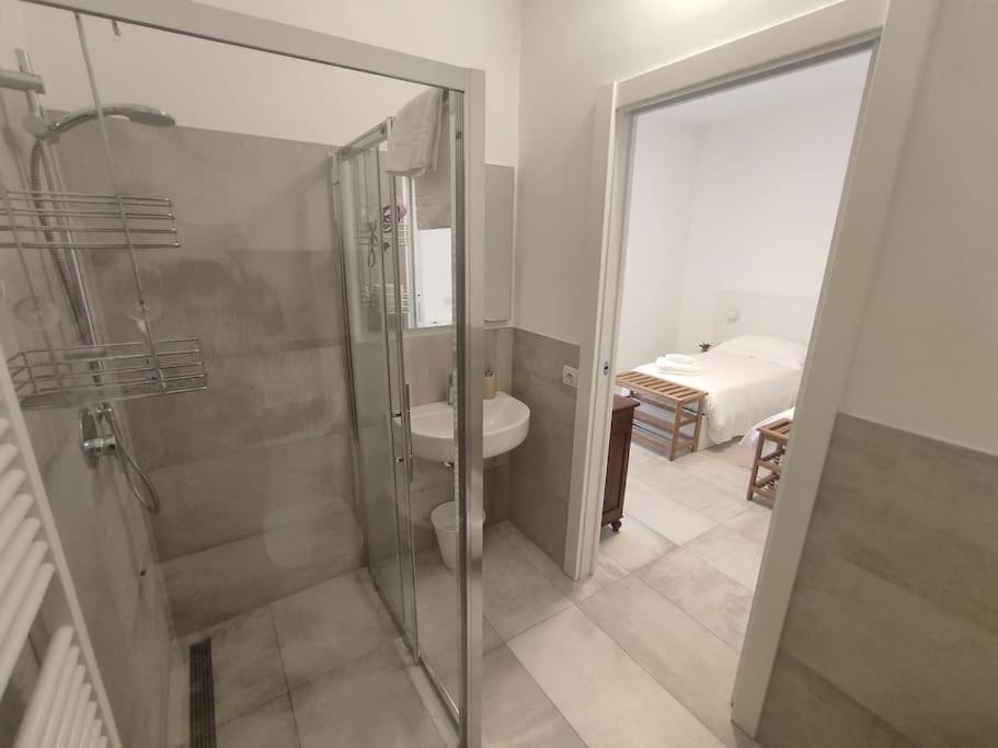 a bathroom with a shower and a toilet and a sink at fuORIOrbita in Orio al Serio