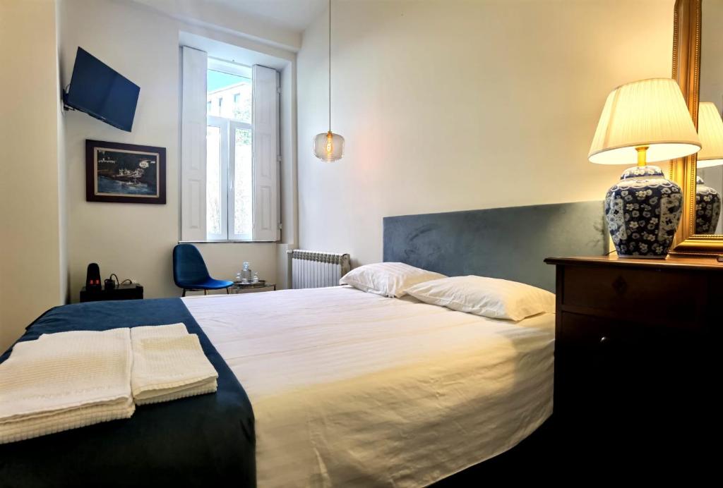 a bedroom with a large bed with a lamp on it at Monsenhor52 in Porto