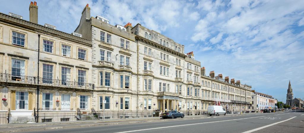 a large white building on the side of a street at Hotel Prince Regent in Weymouth