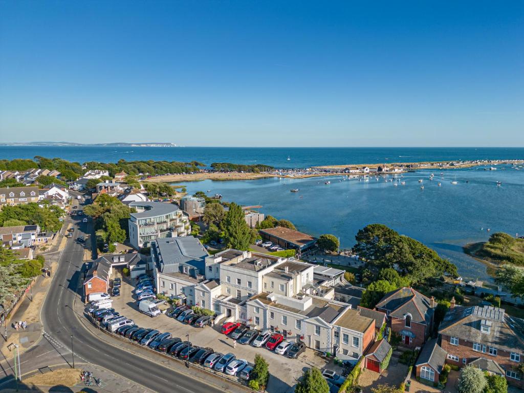an aerial view of a town with houses and the ocean at Christchurch Harbour Hotel & Spa in Christchurch