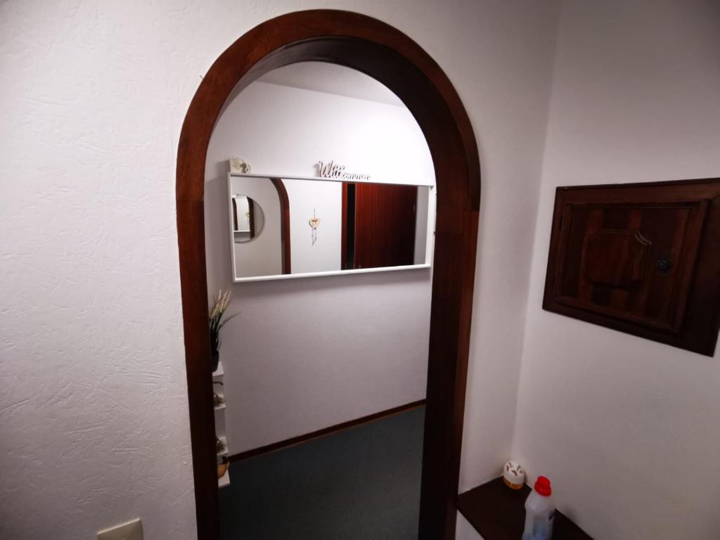 an archway in a hallway with a mirror at Haus Kalli in Walkenried