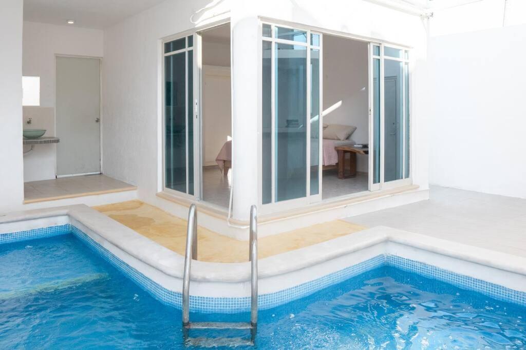 a house with a swimming pool in the middle of it at Casa Medina in Chetumal