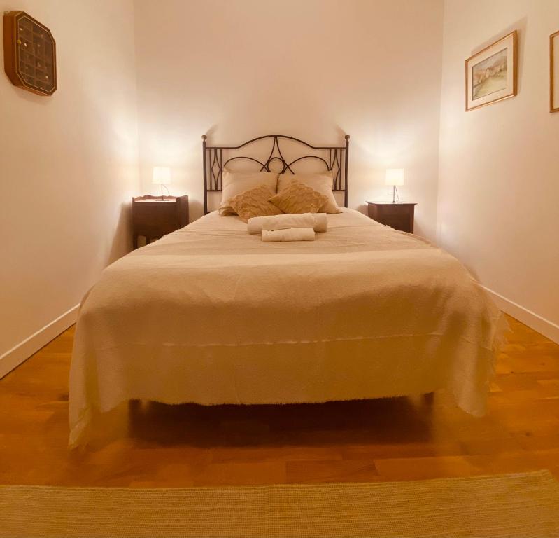 a bedroom with a large bed with two night stands at Monaco border villa Maria in Beausoleil