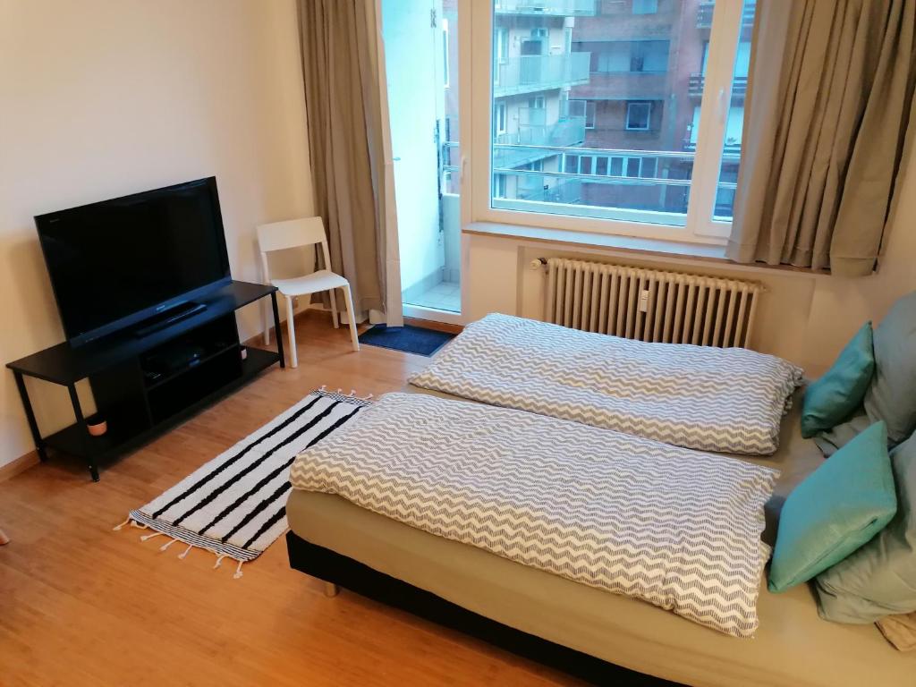Postel nebo postele na pokoji v ubytování studio oostende aan zee