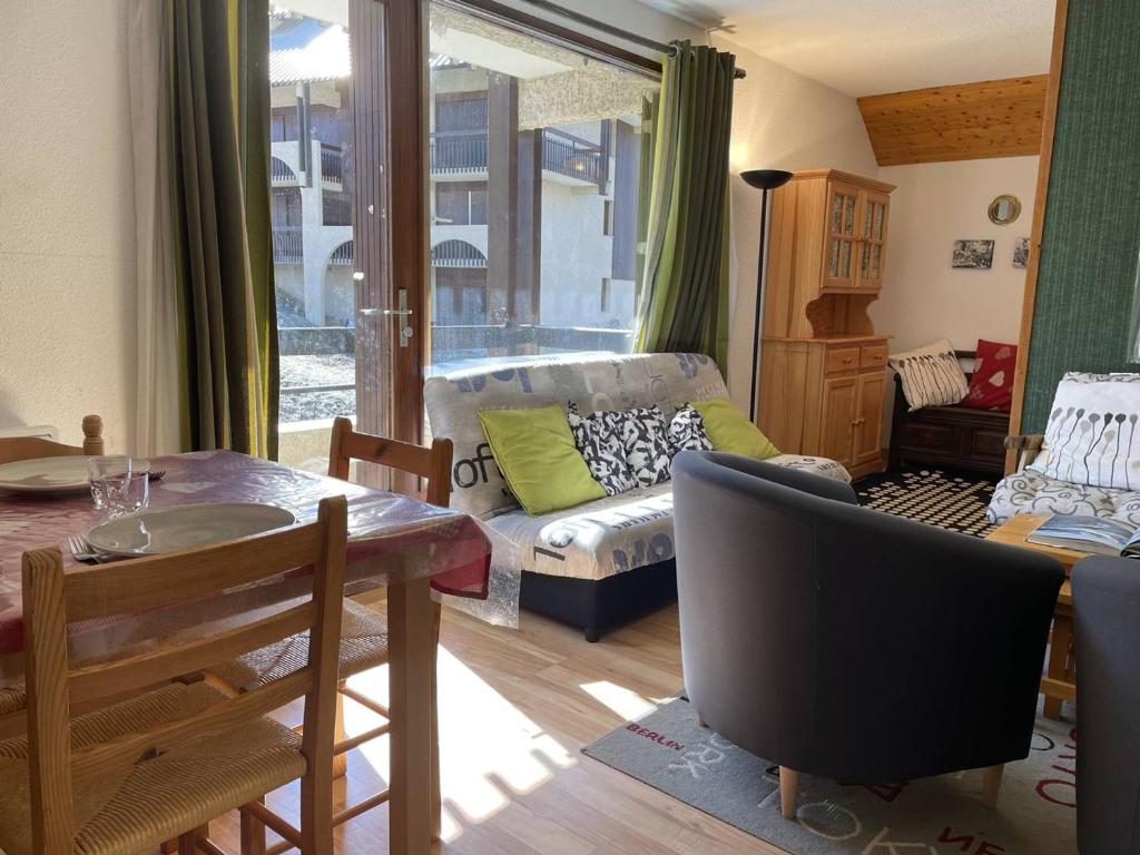 a living room with a couch and a table at Appartement Puy Saint Vincent 1400, 2 pièces, 6 personnes - FR-1-330G-65 in Puy-Saint-Vincent