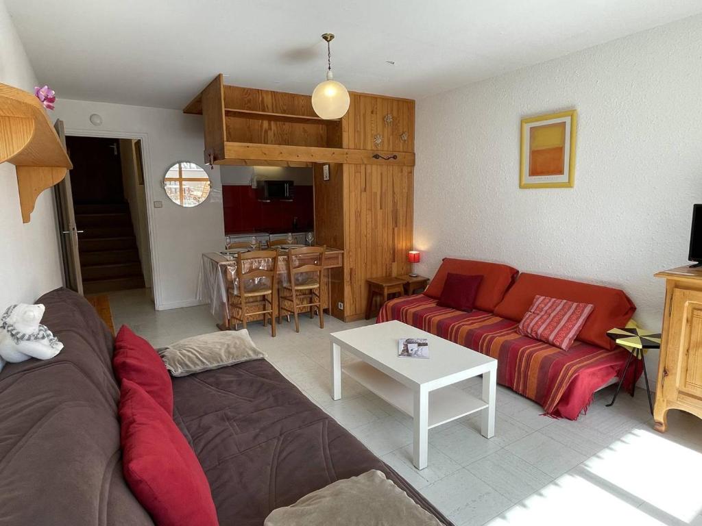 a living room with a couch and a table at Appartement Puy Saint Vincent 1400, 2 pièces, 4 personnes - FR-1-330G-30 in Puy-Saint-Vincent