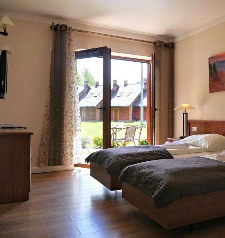 Postel nebo postele na pokoji v ubytování Dolina Leśnicy SKI & SPA Resort