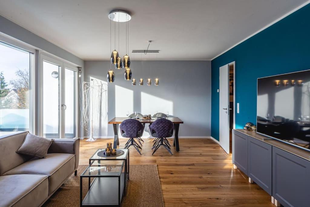 a living room with a couch and a dining room table at A&V Apartments Wunderschöne Penthouse Wohnung in Moers