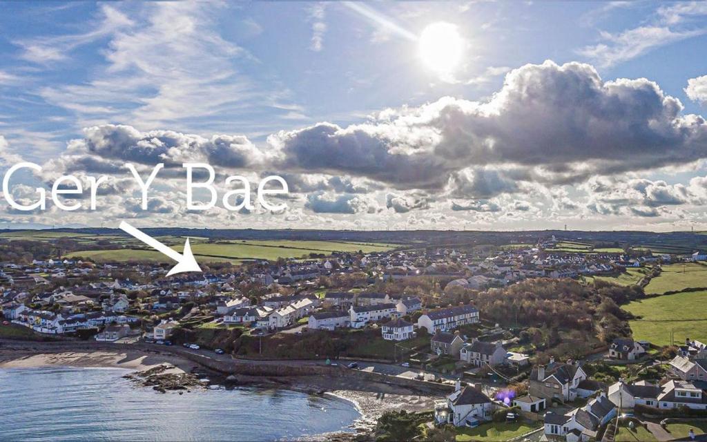 a city with the words cyberlez bar on a cloudy sky at Ger y Bae sleeps 12 in Cemaes Bay