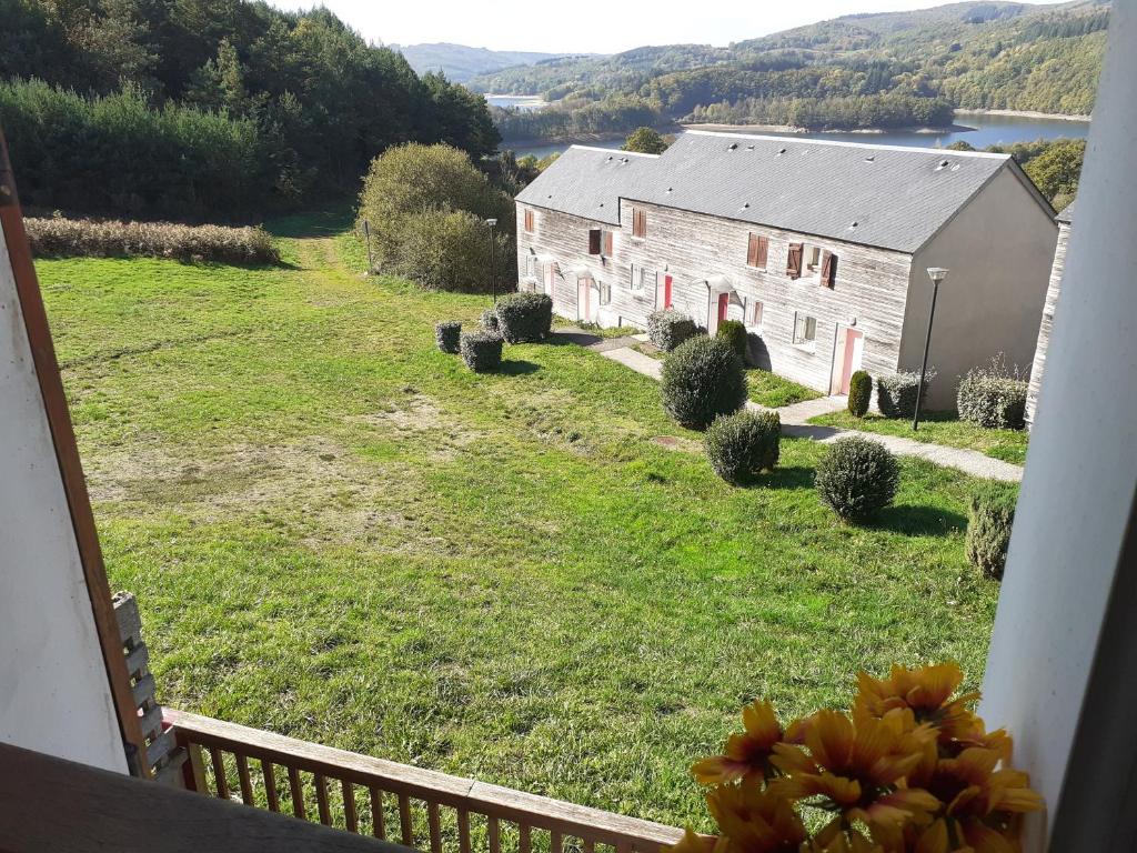 a view of a barn from a balcony of a house at Gîte du Gua des Brasses au bord du lac de la Raviège in La Salvetat