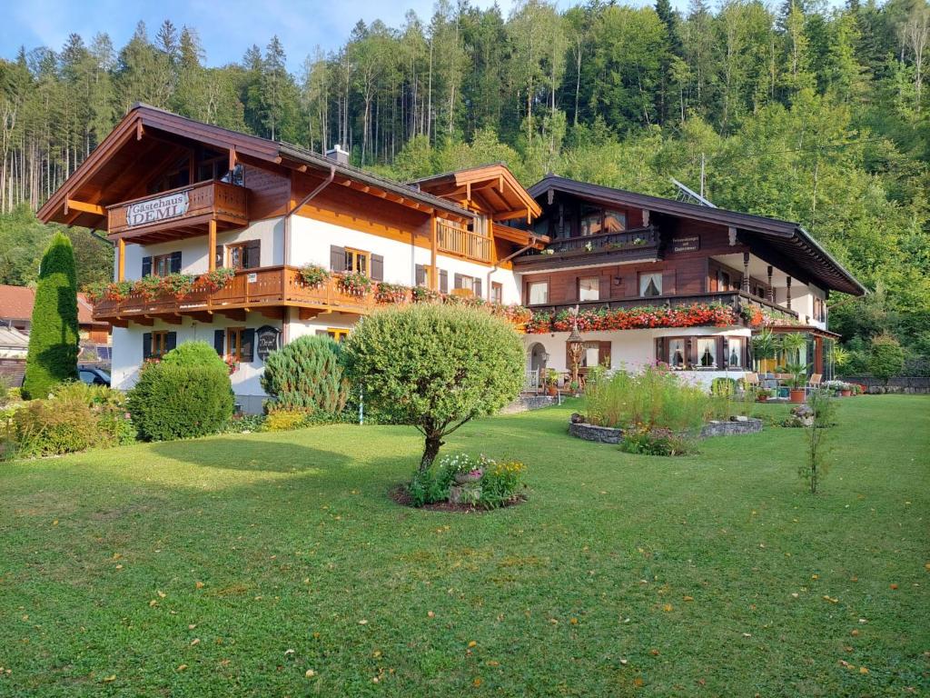 a large house with a green lawn in front of it at Gästehaus Deml in Berchtesgaden