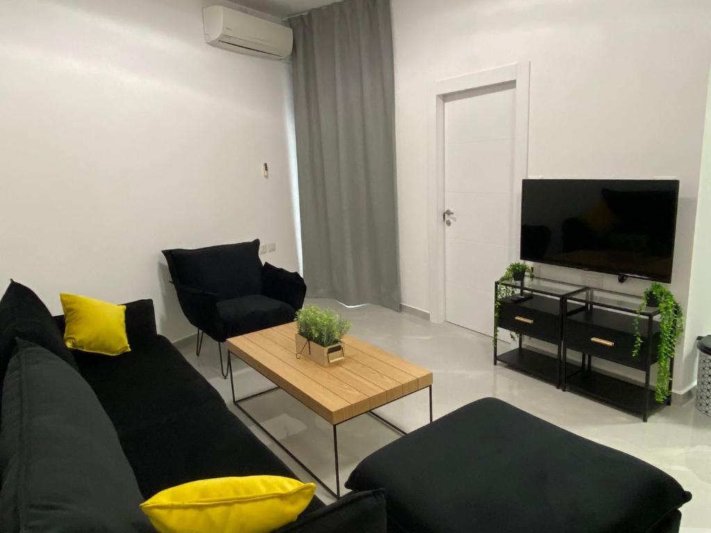 a living room with a couch and a table at Sima Suite 2 in Ashdod