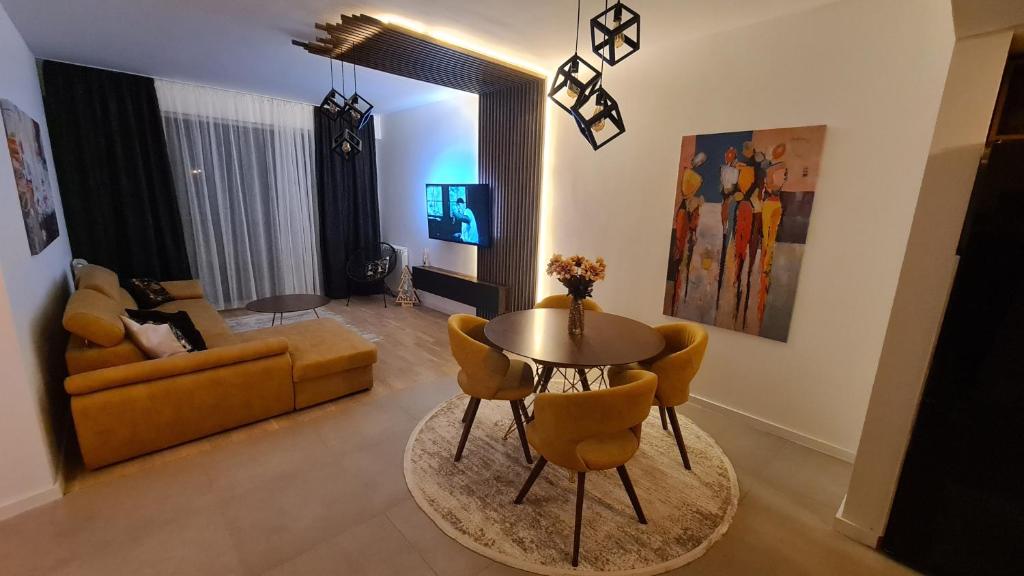 a living room with a table and chairs and a couch at Anika Sweet Apartment at Vodno in Skopje