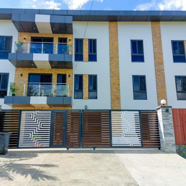 a building with a facade with wooden doors at Breeze Apartments in Nadi