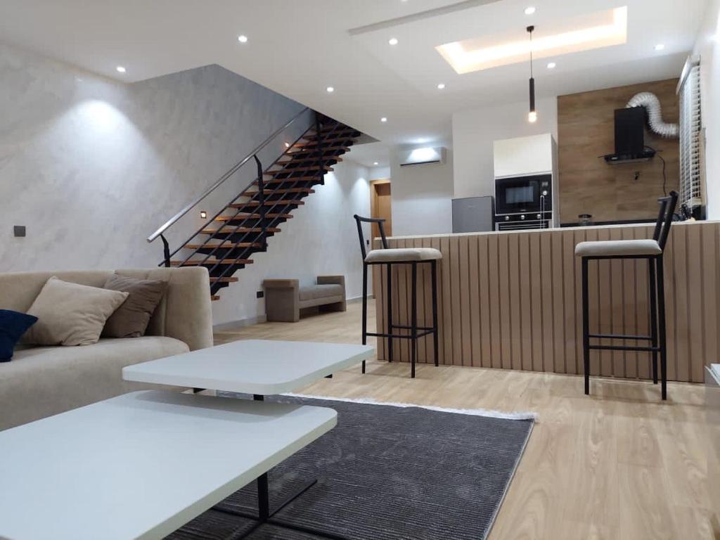 a living room with a couch and a staircase at Harbor Pond Apartments 2 in Lagos