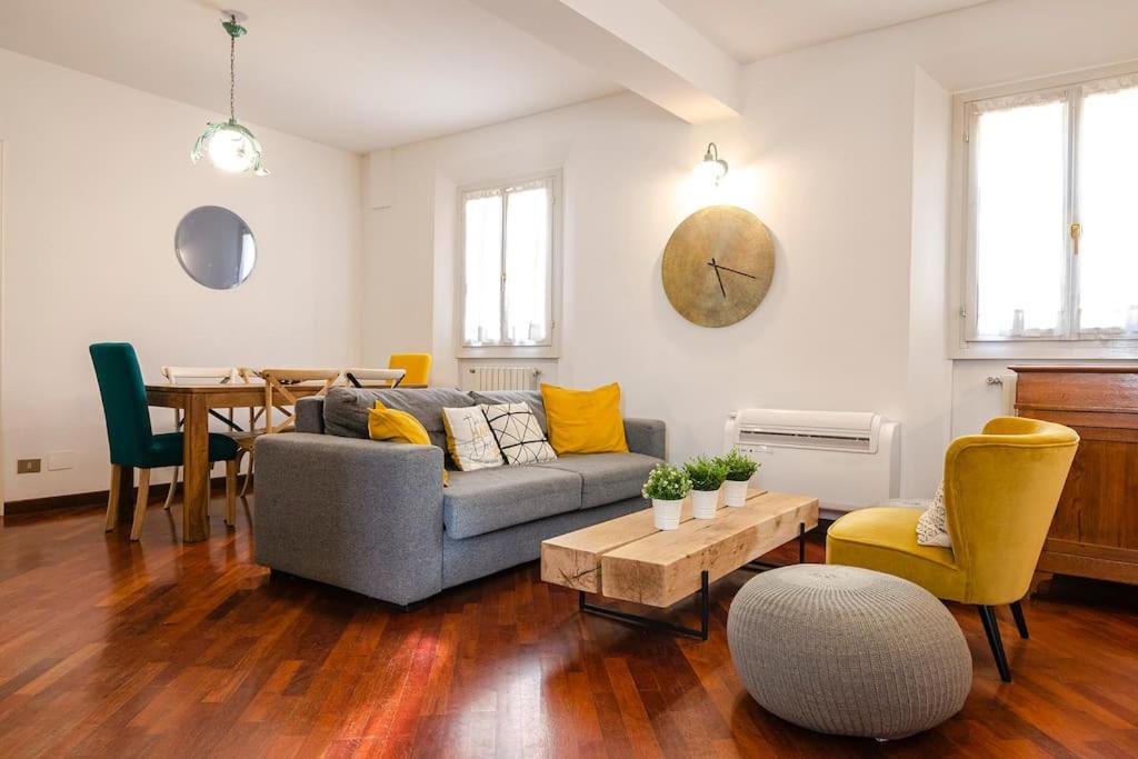 a living room with a couch and a table at Griffoni Home, in the Heart of the City in Bologna