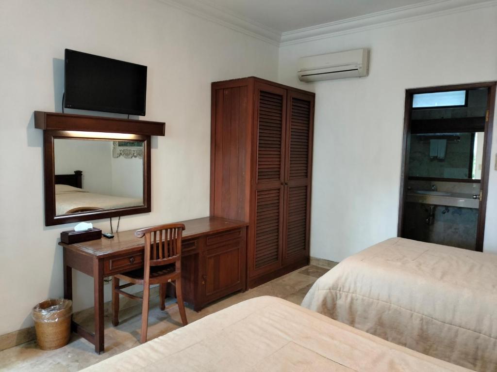 Postel nebo postele na pokoji v ubytování Grand Kumala Hotel - Hotel Kumala Legian Kuta Bali