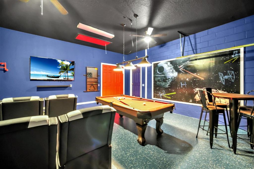 a billiard room with a pool table and a blue wall at Themed Decor With Tv In Every Bedroom in Davenport
