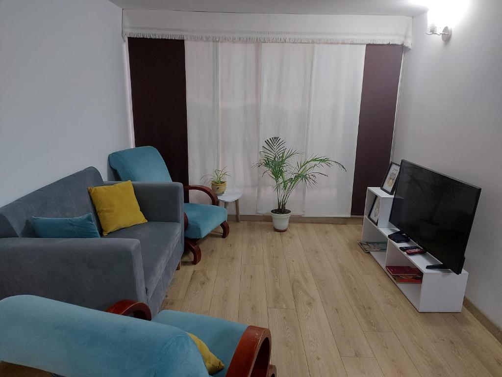 a living room with a couch and a tv at Apartamento Luna 170 in Bogotá
