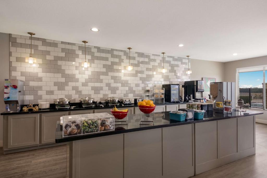 a kitchen with a counter with bowls of food on it at Best Western Plus Killeen - Fort Cavazos Hotel & Suites in Killeen